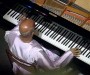 Sri Chinmoy performs on the piano in Malta